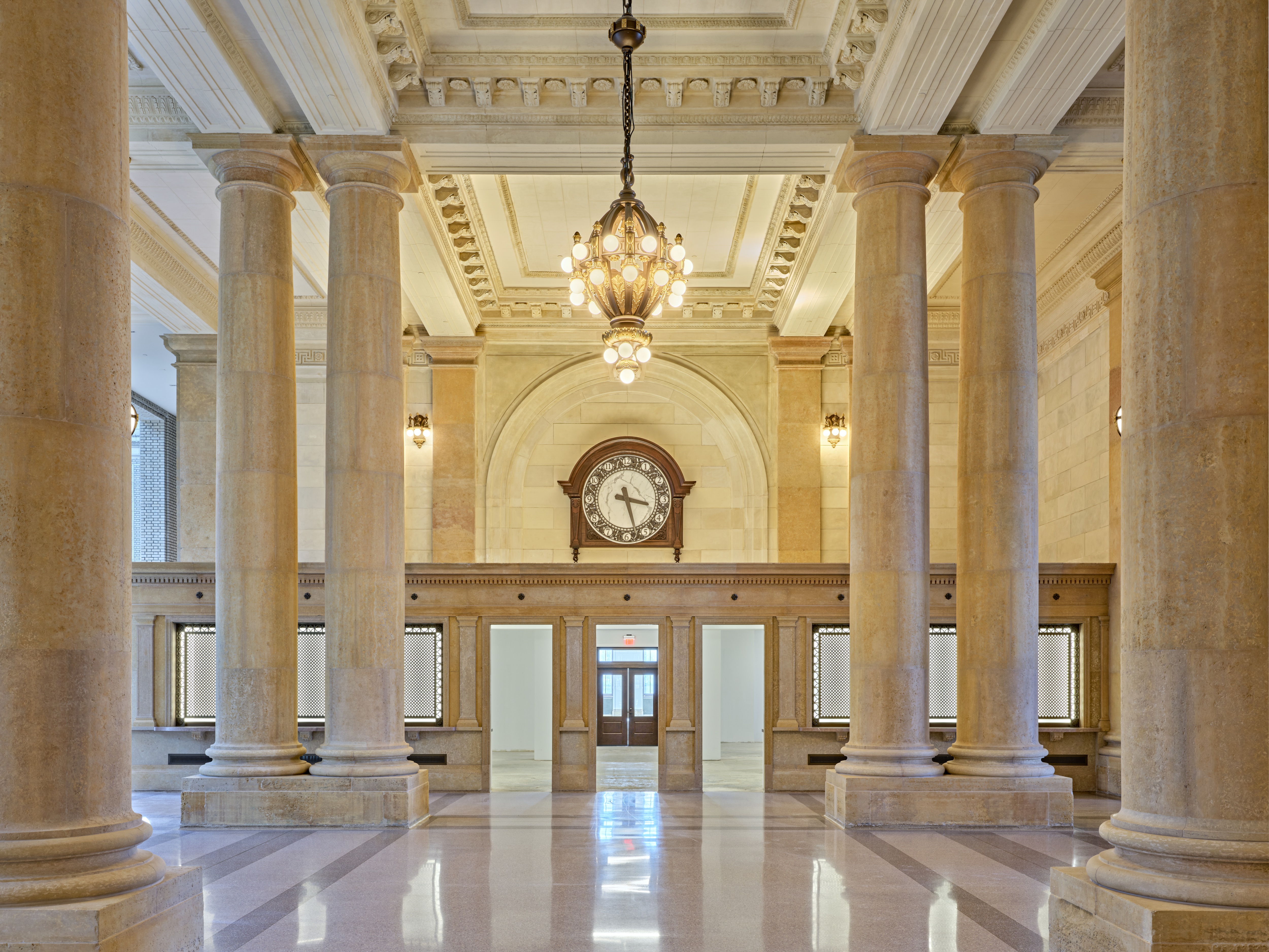 Columns, a chandelier and a large clock are pictured in Michigan Central Station